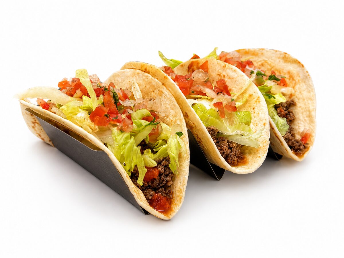 Three Nachoz tacos loaded with seasoned filling, lettuce and pico de gallo